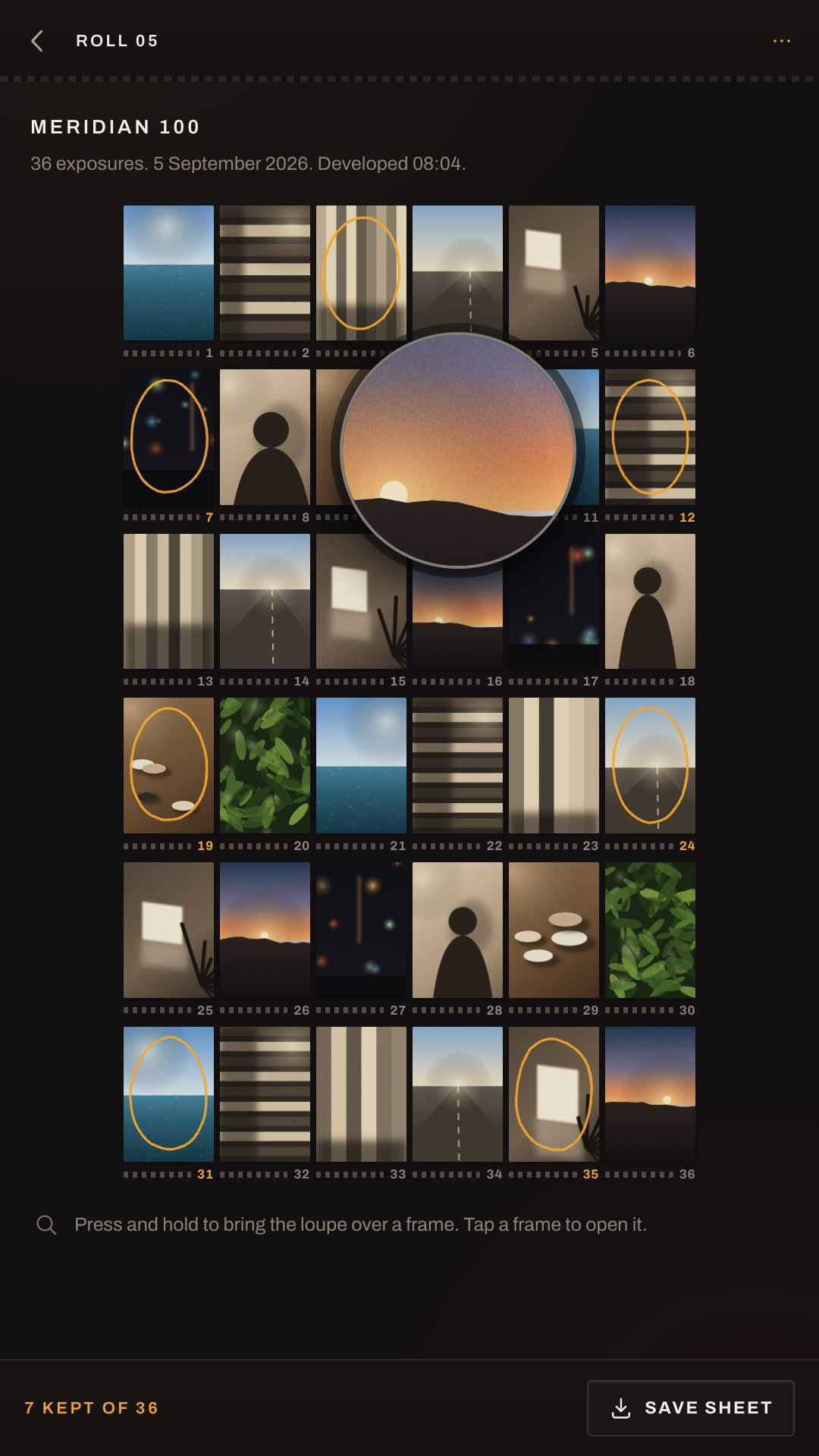 A round magnifier hovering over one frame of the contact sheet, showing its grain.
