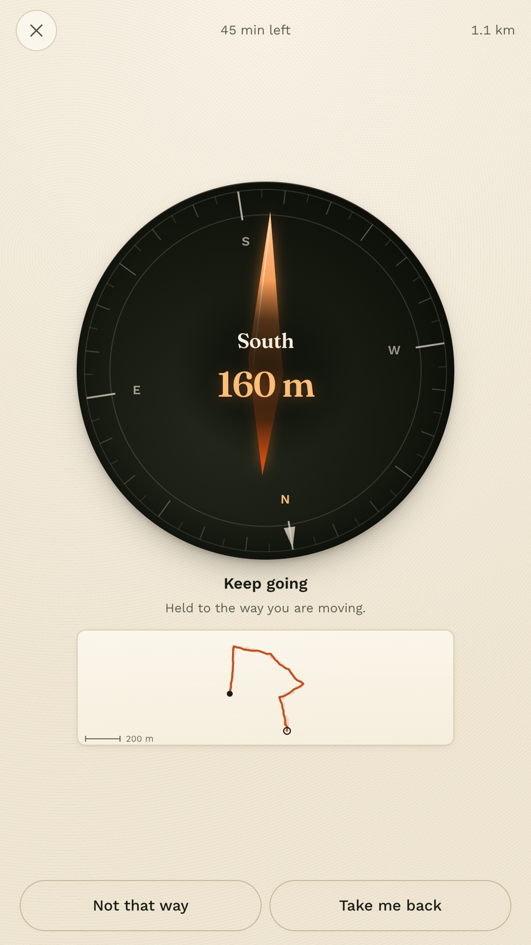 The walk screen: a black compass card with a tangerine needle, the word East, and seventy metres to go.