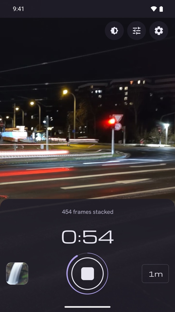 Slowglass building light trails from a night street, 54 seconds into a one minute exposure